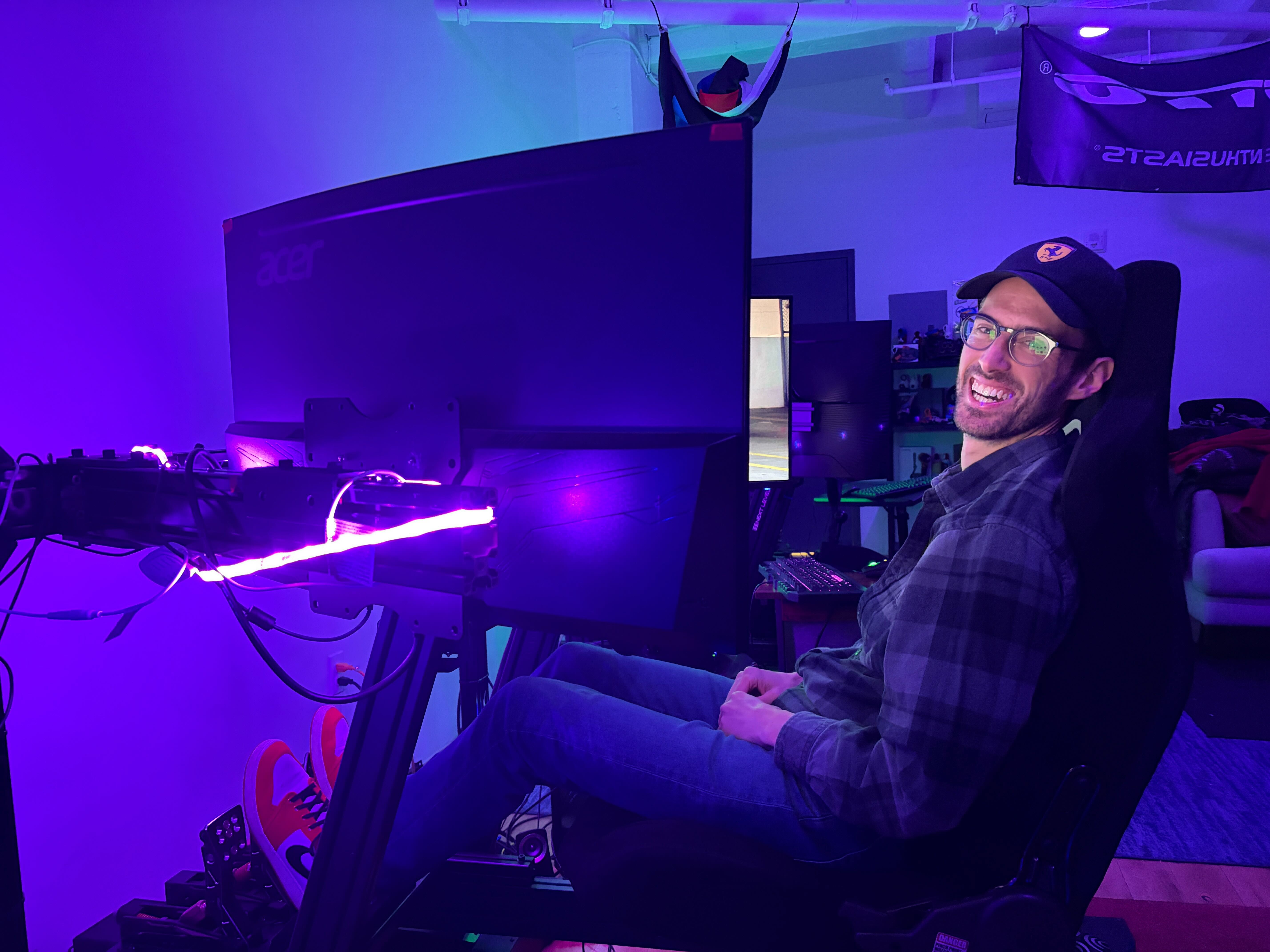 Kyle Libra at his sim racing rig — a full racing simulator setup used for Formula 1 and endurance racing practice